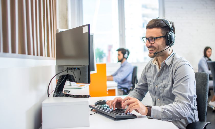 man working at a computer in a contact centre